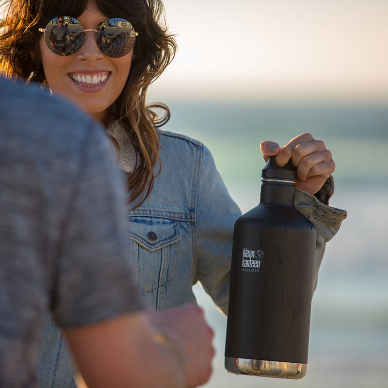 64oz-classic-with-loop-cap-q8 64oz_insulated_classic_black_beach_girl_hand_square.jpg