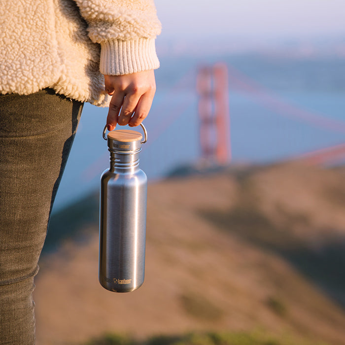 27oz-reflect-with-bamboo-cap-q4 K27SSLRF-BS-BAMBOO_reflect_bottle_bridge_lifestyle.jpg